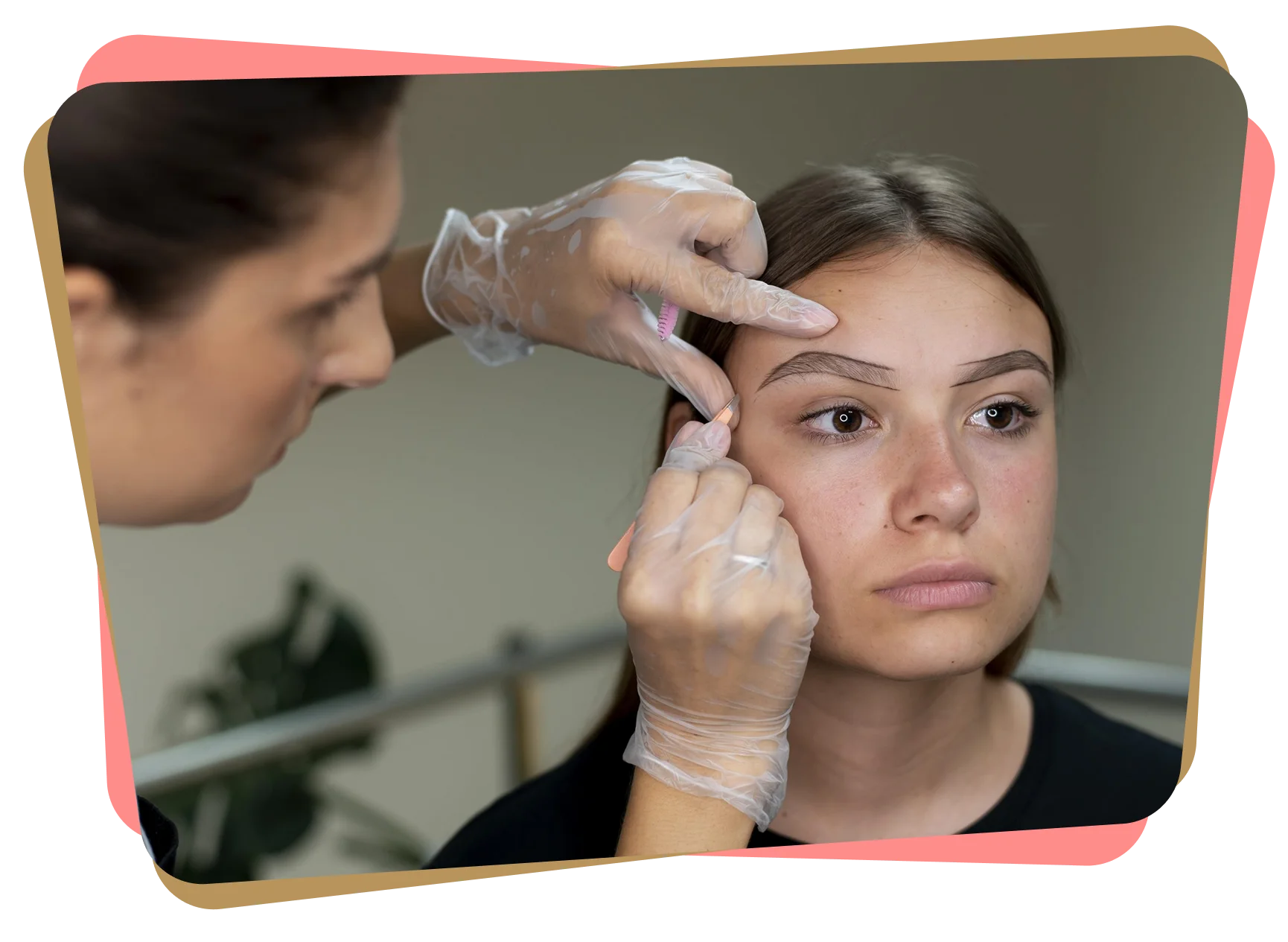 Close-up of a woman receiving eyebrow shaping treatment while a practitioner wearing gloves outlines and adjusts her brow shape.
